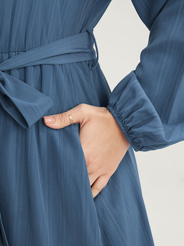 Solid Surplice Neck Lantern Sleeve Pocket Belted Asymmetrical Hem Dress